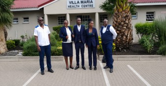 Villa Maria Health Centre staff outside the main entrance